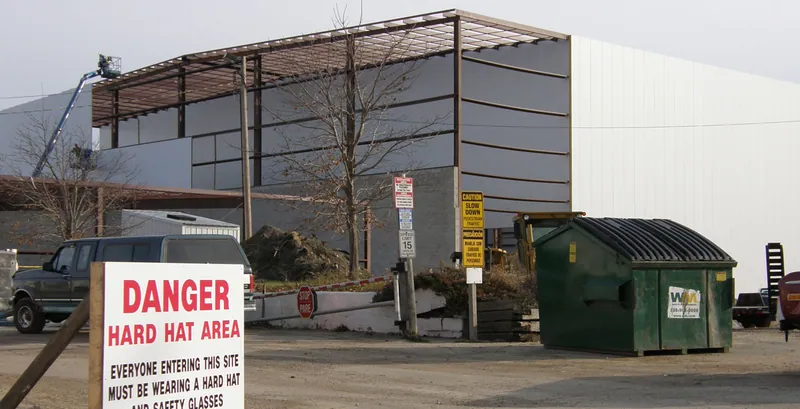 Steel framing for the Echo Lake Foods addition with a hard hat area sign