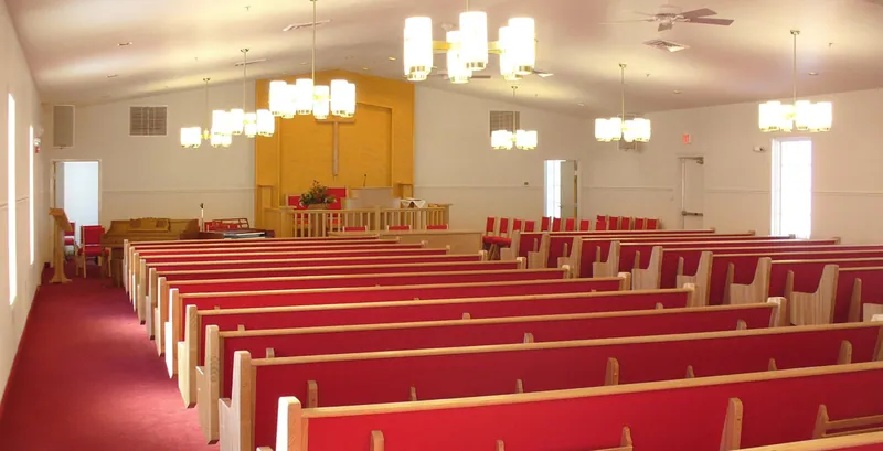 Israel of God Church sanctuary with red pews and chandeliers