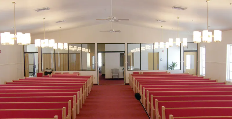 Israel of God Church sanctuary seen from the front, with glass-walled rooms at the back