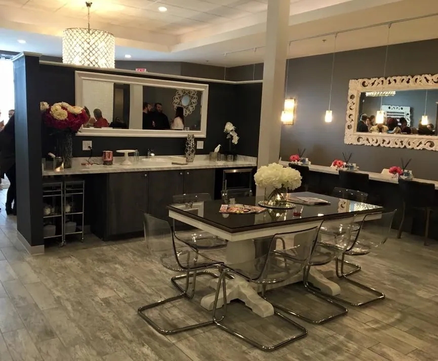 Polished Beauty Bar salon interior with chandelier and dark cabinetry
