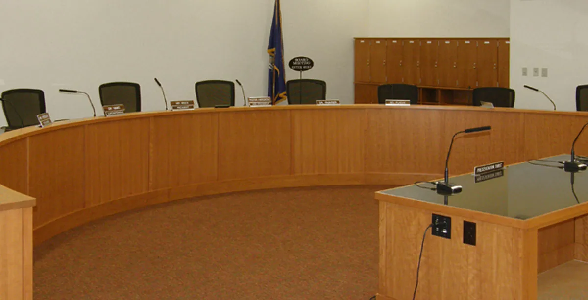 Racine Unified School District board room with curved wood dais