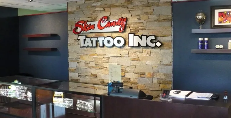 Skin Candy Tattoo reception counter with stone feature wall and logo