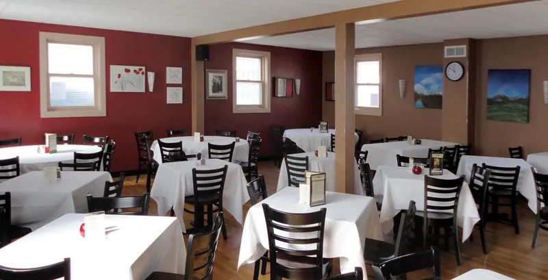 Twisted Cuisine dining room with white tablecloths and red accent walls