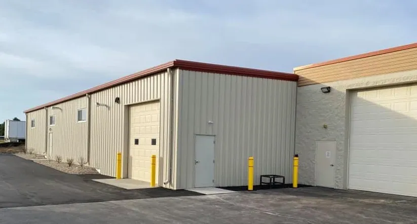 Pre-engineered metal building with overhead doors and masonry addition