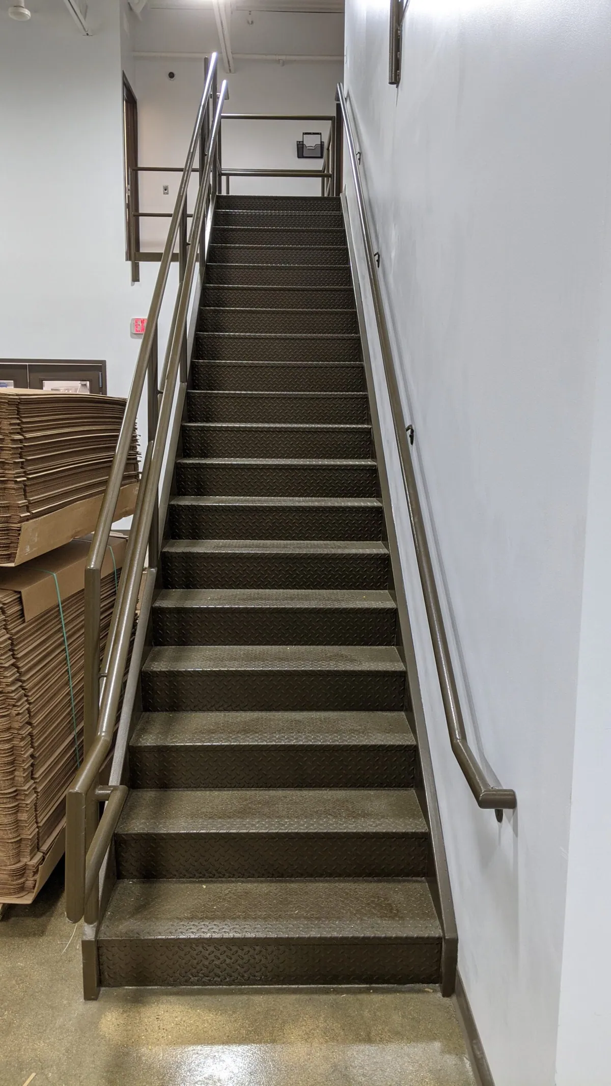 New stairway with handrail in the commercial buildout