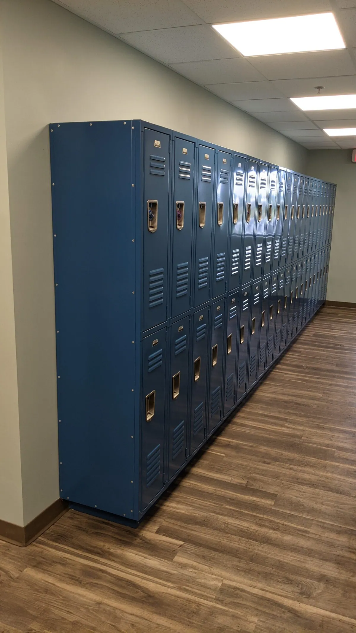 Row of blue employee lockers in a new hallway
