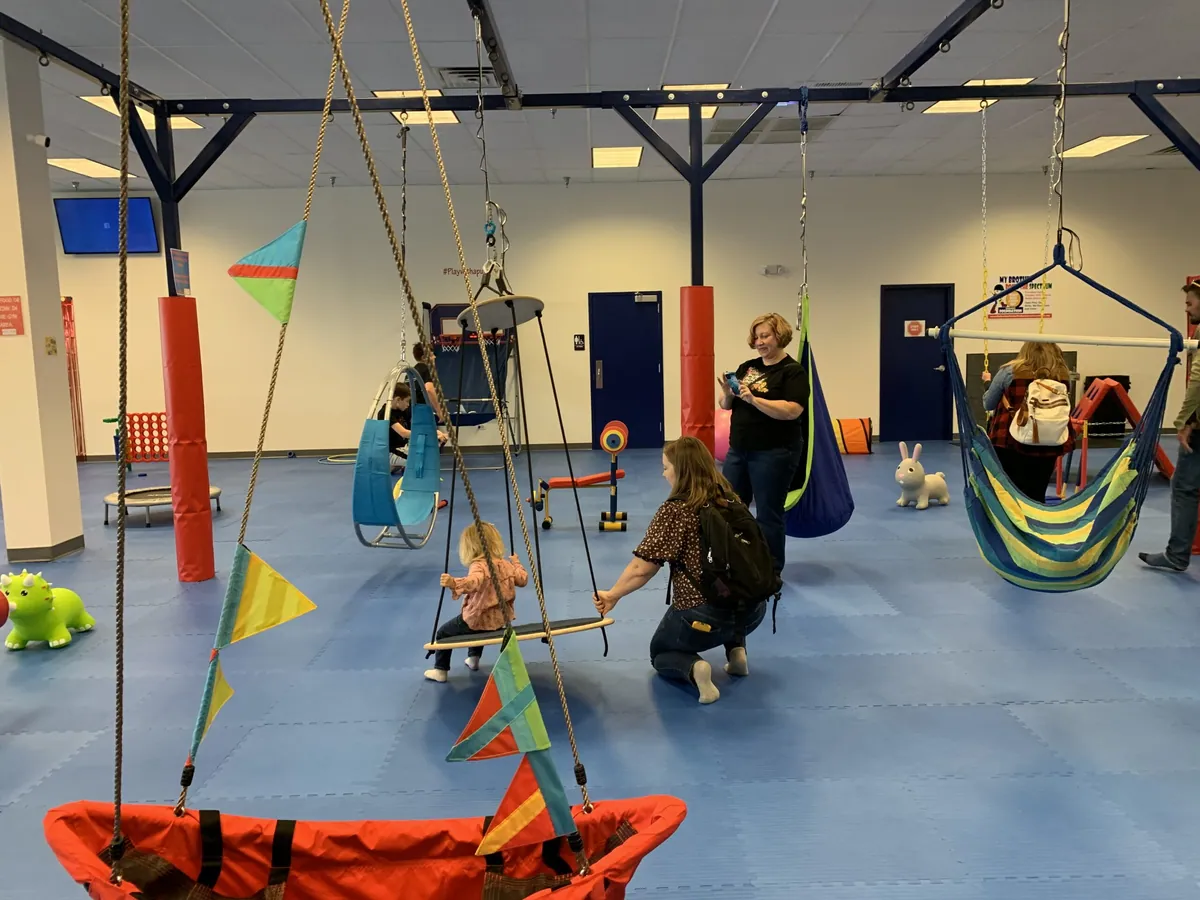 Swings and hammocks in the We Rock the Spectrum play gym