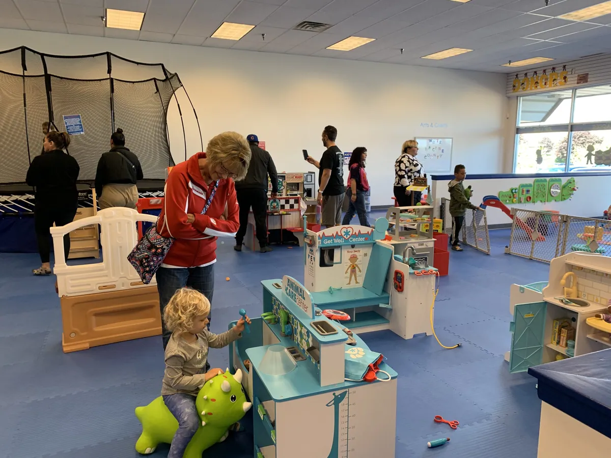 Children at play kitchens and toys at We Rock the Spectrum