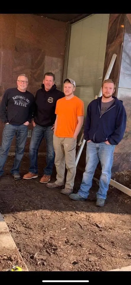 Four Katt brothers standing on a construction site