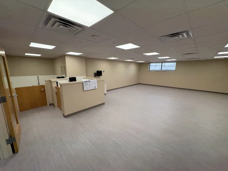 Daycare room after renovation, with new flooring and reception counter