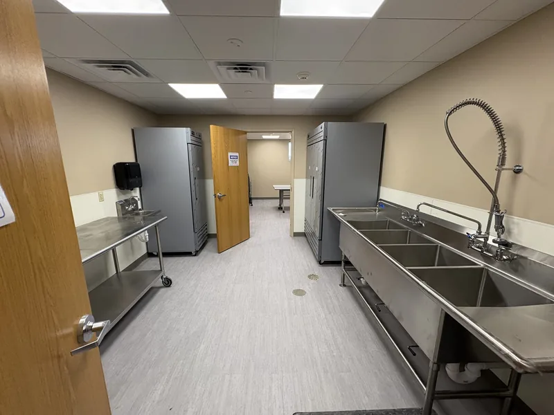 Renovated daycare kitchen with stainless steel sinks and refrigerators