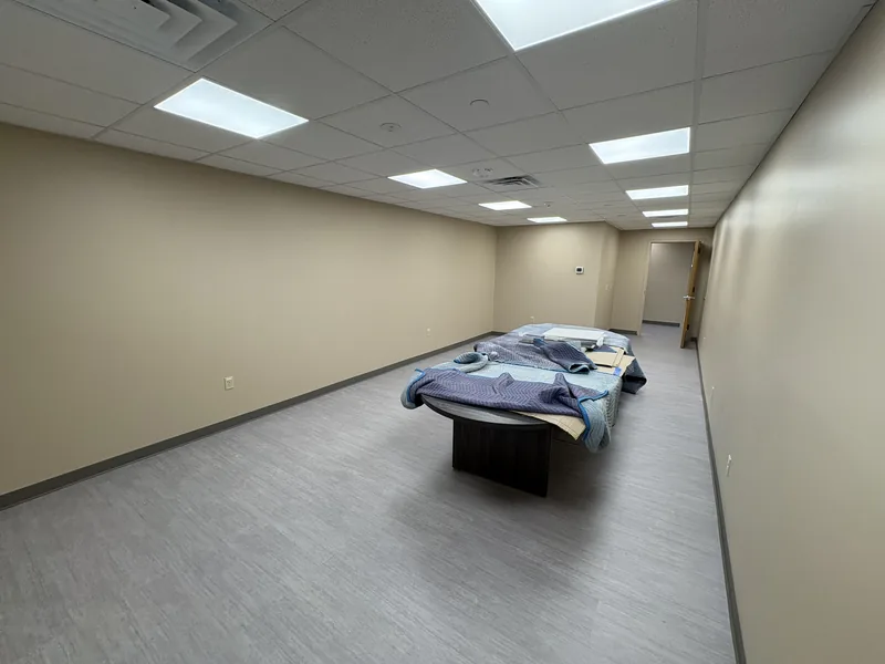 Renovated daycare room with new flooring and ceiling lights